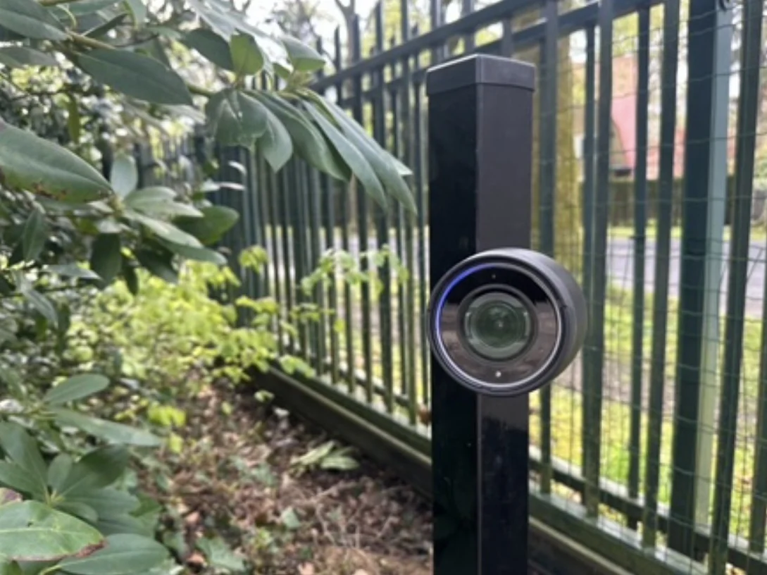 Camera op een paal langs het hek, kijkt over de rand van het perceel